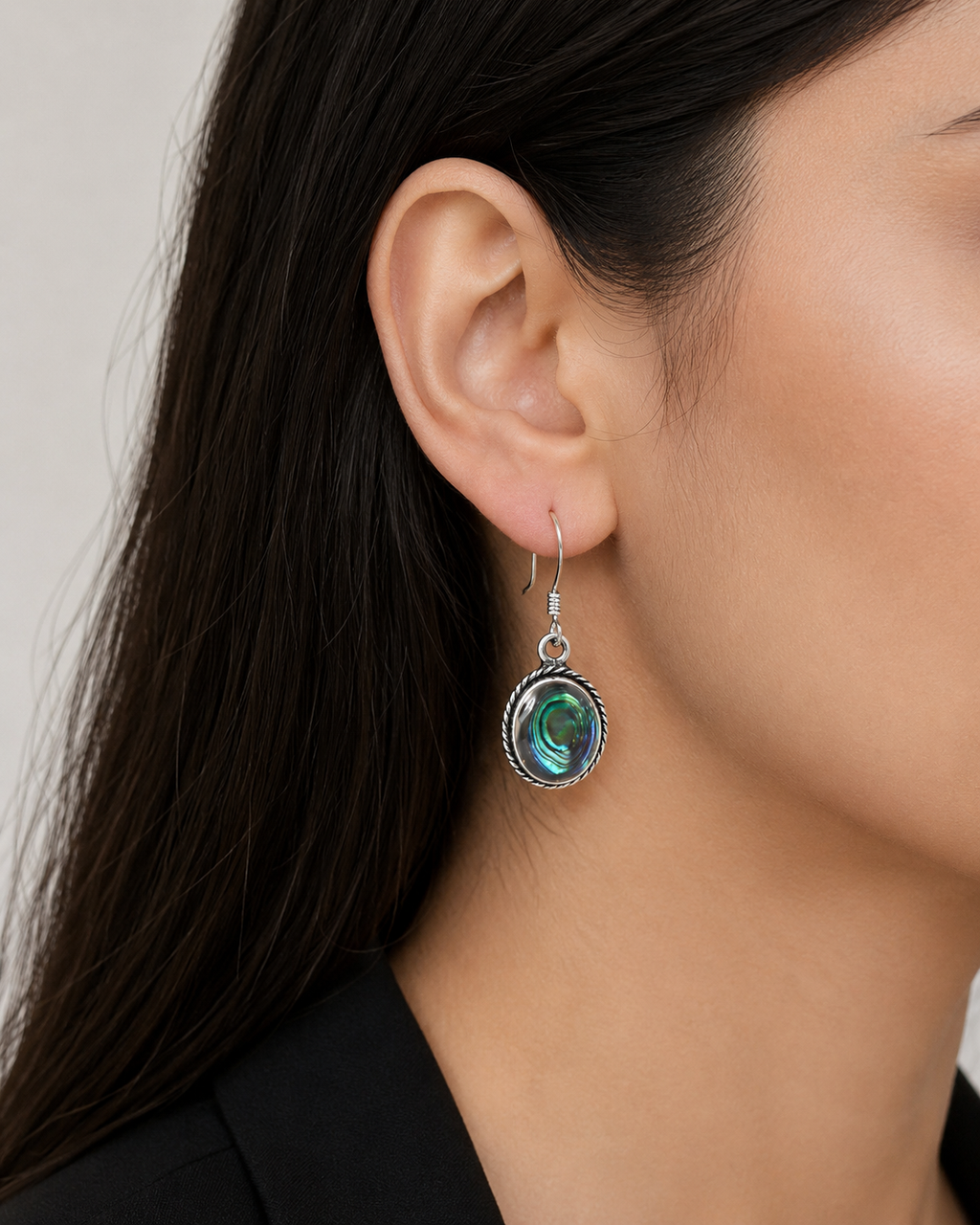 Elegant silver earrings with a shimmering shell stone and a soft modern design.
