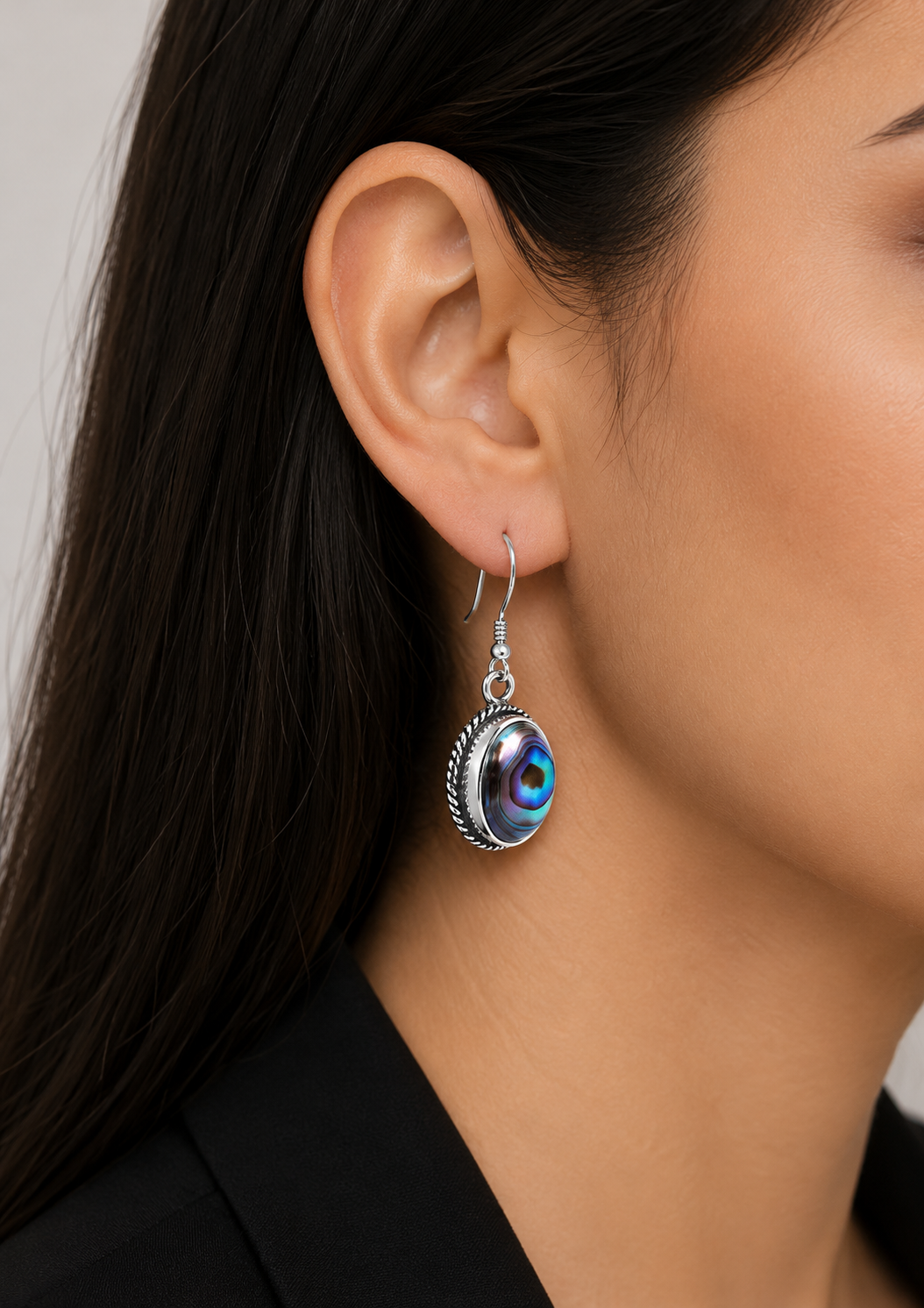 Elegant silver earrings with a shimmering shell stone and a soft modern design.